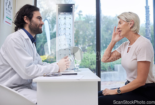 Image of Eye doctor, senior or woman consulting for eyesight advice at optometrist or ophthalmologist with medical aid. Customer talking or asking questions to check vision health with a trusted optician