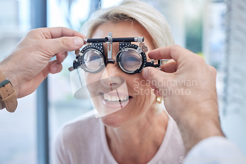 Image of Happy customer in a vision test or eye exam for eyesight by doctor, optometrist or ophthalmologist with medical aid. Hands, helpful or optician consulting a senior woman to see or check glaucoma