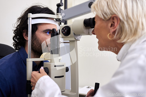 Image of Patient, eye exam or test for vision with laser lens and doctor at optometry consultation. Man and woman healthcare person with machine for eyes, wellness and health insurance with expert care