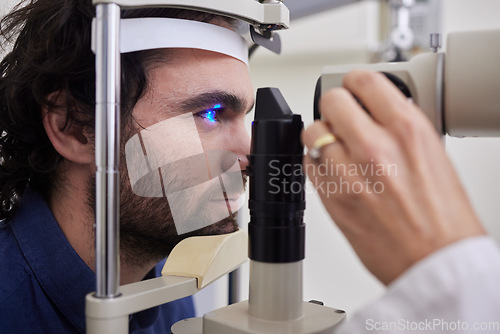 Image of Eye exam, care or laser test for patient with machine at optometry consultation for lens or vision. Face of man and doctor hands for eyes, eyesight and check with health insurance for wellness