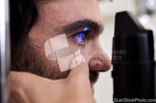 Image of Eye exam, vision or laser test for patient with machine at optometry consultation for retina problem. Hands, eyesight or doctor helping or checking a man or client with health insurance for wellness