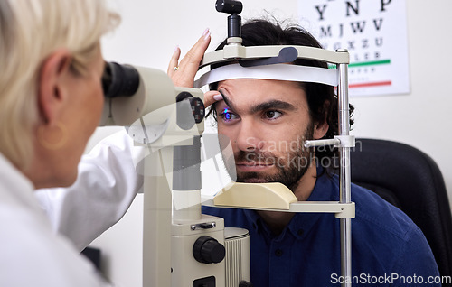 Image of Patient man, eye exam or test for vision with laser lens and doctor at optometry consultation. Person and woman healthcare person with machine for eyes, wellness and health insurance with expert care