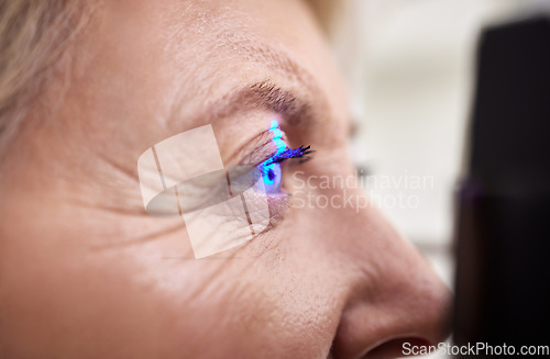 Image of Eye exam, vision or laser test for an old woman with a machine at optometry consultation for retina problem. Senior, patient or client with medical health insurance checking eyesight at optician