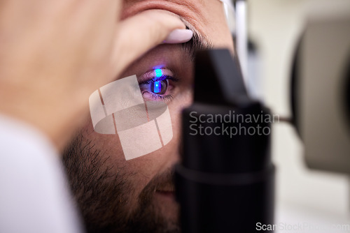 Image of Eye exam, vision or laser test for a man with machine at optometry consultation for retina problem. Hands, eyesight or doctor helping or checking a patient or client with medical insurance for health