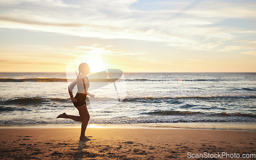 Image of Woman, fitness and running on the beach sunset for healthy cardio exercise, training or workout in the outdoors. Female runner exercising in sunrise for run, health and wellness by the ocean coast