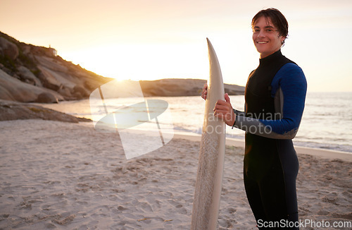 Image of Surfer, surf and portrait of teenager with surfboard at the beach, sea and ocean in sunset with mockup space. Young, ready and male in swimsuit on a sunny day on the sand, shore and water in summer