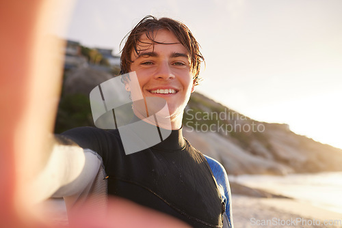 Image of Selfie, surfing and beach with a sports man outdoor in nature on the sand by the sea or ocean for recreation. Portrait, face or surf with a male athlete posing for a photograph outside in the morning