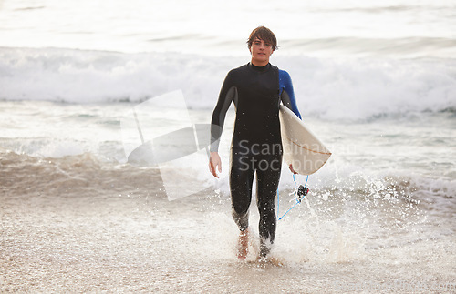 Image of Summer, surfing and portrait of a man at the beach for water sports, relaxation and holiday in Bali. Sporty, training and surfer with a board for exercise, ocean break and activity on a vacation