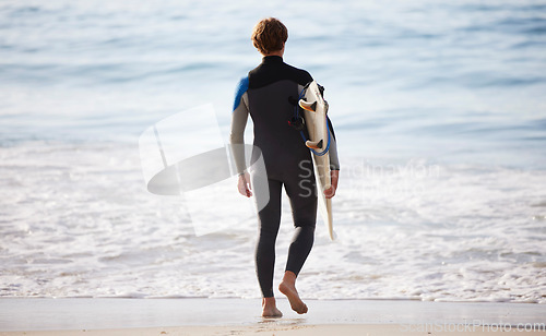 Image of Surfer on beach, man with surfboard for sports outdoor, ocean and travel with mockup space and nature. Adventure, extreme sport and athlete walk, active lifestyle and surfing in Miami with back view