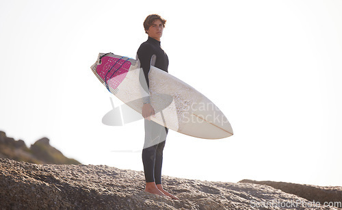 Image of Surfing, man with surfboard for sports outdoor, beach rocks and travel with mockup space and nature. Adventure, extreme sports and surfer portrait, active lifestyle with surf training in Australia