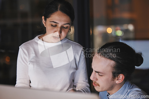 Image of Working, talking and office team by a computer at night planning a company collaboration. Work conversation, teamwork and it startup employee group with communication of a tech strategy at a desk