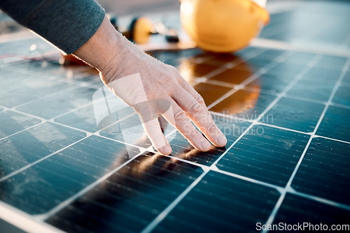 Image of Hands, engineer and solar panel in construction for renewable energy, electricity or technology. Hand of electrician or technician feeling heated plates for quality, sun or testing power on building