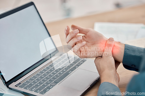 Image of Laptop, office and business woman with wrist pain, injury or accident while working on a project. Stress, medical emergency and professional female with a sprain muscle on a computer in the workplace