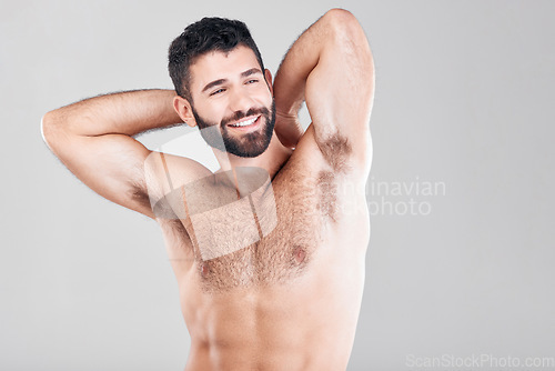 Image of Fitness, body and man with muscles in a studio after a bodybuilding workout or sport training. Health, wellness and muscular male model flexing his biceps while posing isolated by a gray background.