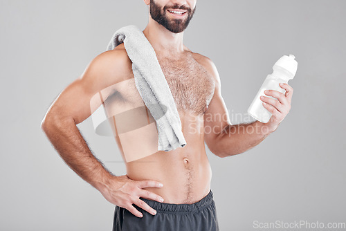 Image of Fitness, exercise and man with water bottle, towel and workout for wellness, healthy lifestyle and grey studio background. Male, athlete or liquid for after training, practice or endurance for energy