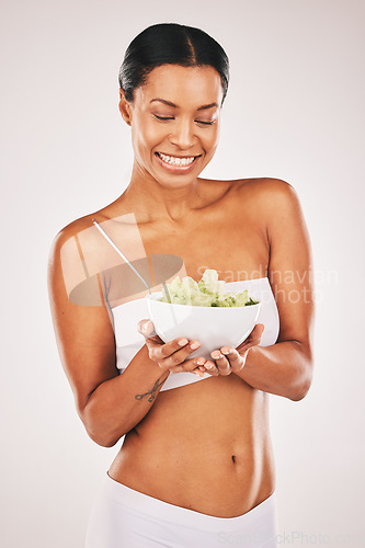 Image of Health, smile or woman with grapes in a studio for a healthy snack, nutrition diet or heart benefits. Body goals, lose weight or happy young female model eating fruits isolated by a white background