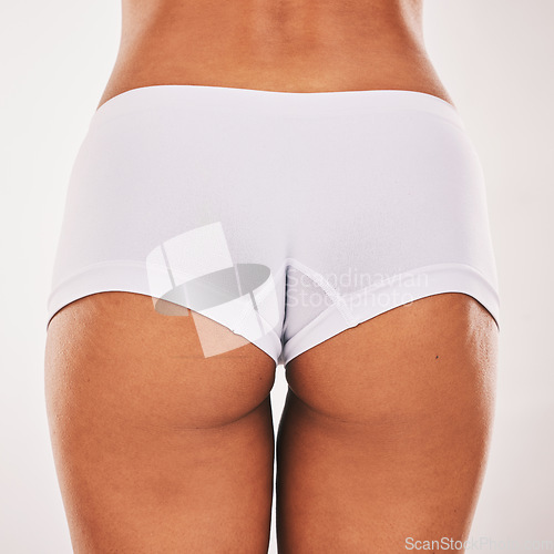 Image of Buttocks, underwear and closeup with a model black woman in studio on a gray background from the back. Skin, real and bum in panties with a normal female posing to promote natural body positivity