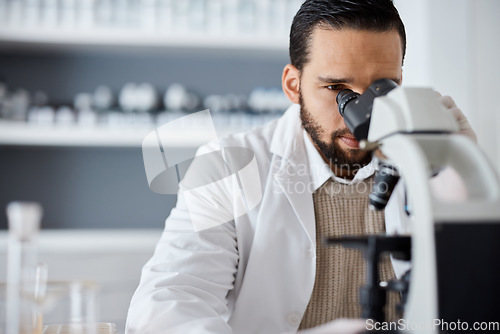 Image of Science, microscope and analytics with a doctor man at work in a laboratory for innovation or development. Medical, research and biotechnology with a male scientist working in a lab for breakthrough