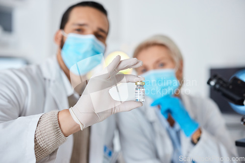 Image of Science, man or woman with vial, research or data analysis for cure, results or vaccine in lab. Male researcher, female scientist or test tube for experiment, breakthrough or healthcare in laboratory