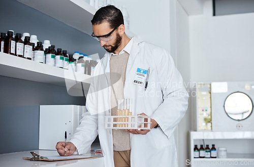 Image of Science, writing and man with test tube in laboratory with clipboard for results, medical report and research. Pharmaceutical, health and scientist write notes for liquid sample, medicine and vaccine