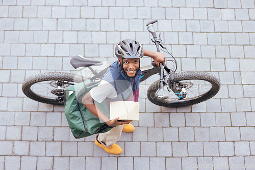 Image of Bicycle, delivery and black man with courier services, package and ecommerce transport in portrait above. Box, logistics and carbon footprint driver with stock product, business and career bike