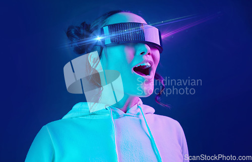 Image of Metaverse, headset and shocked woman in a virtual reality in studio for futuristic innovation technology. Digital simulation, gaming and female with vr goggles for cyber tech by dark blue background.