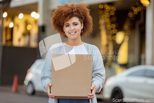 Image of Moving box, black woman and happiness outdoor by new home apartment building with a smile. Real estate, investment and young person holding boxes feeling happy about mortgage and property sale