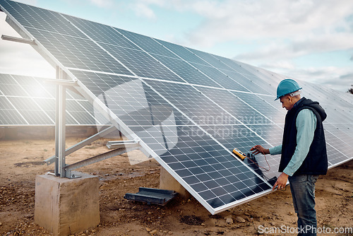 Image of Renewable energy, solar panel and senior construction worker outdoor working on grid. Industrial engineer, sustainability and eco friendly development of a mature engineering employee and handyman