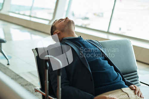 Image of Airport, travel and tired businessman sleeping while waiting to board his plane for work in city. Exhausted, rest and professional corporate male employee taking nap while traveling with flight delay