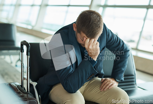 Image of Airport, headache and stress man waiting to travel, frustrated and sad for transport delay, crisis or problem. Immigration, anxiety and person thinking, fail or mistake for international flight news