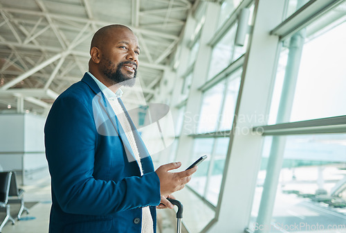 Image of Black man, phone and thinking at airport window for business travel, trip or communication waiting for flight. African American male with smile contemplating schedule or plain times on smartphone