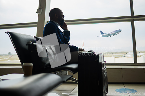 Image of Black man, phone call and luggage at airport for business travel, trip or communication waiting for flight. African American male in conversation or discussion on smartphone ready to board airplane