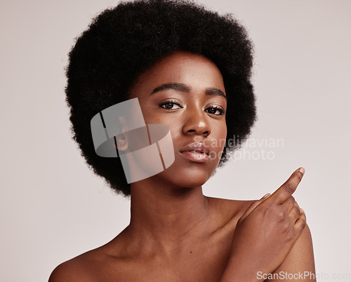 Image of Portrait, beauty or skin and a model black woman in studio on a gray background with afro hair. Skincare, cosmetics and natural with an attractive young female posing indoor for health or wellness