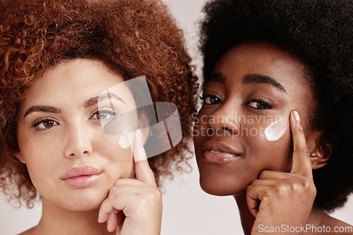 Image of Skincare, face cream and portrait of women in a studio for a wellness, health and natural routine. Beauty, cosmetic and interracial females with facial moisturizer, spf or lotion by nude background.