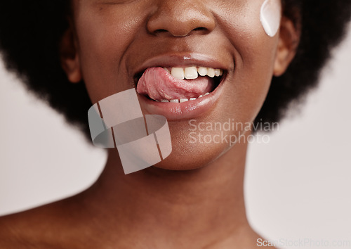 Image of Beauty, face or tongue over teeth in dental care, mouth hygiene or oral wellness in healthcare grooming. Zoom, black woman or model licking lips in skincare product glow, clean orthodontics or makeup