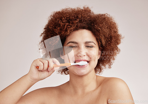 Image of Happy woman, brushing teeth and toothbrush for clean and healthy mouth on studio background. Face of person advertising dentist tips for dental care, hygiene and cleaning with a mint breath smile