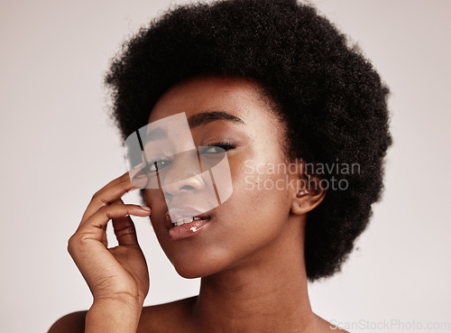 Image of Portrait, beauty or natural and a model black woman in studio on a gray background with afro hair. Skin, cosmetics and skincare with an attractive young female posing indoor for health or wellness