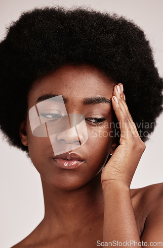 Image of Black woman, skincare and beauty secret of a model with skin glow from dermatology. Facial, self care and wellness of an African female in a isolated white background in a studio with cosmetics