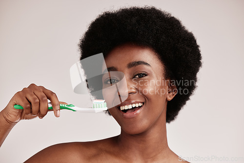 Image of Brushing teeth, black woman and toothbrush portrait for clean and healthy mouth on studio background. Face of happy person advertising dentist tips for dental care, hygiene and cleaning with a smile