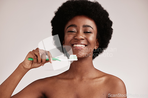 Image of Black woman, brushing teeth and toothbrush portrait for clean and healthy mouth on studio background. Face of happy person advertising dentist tips for dental care, hygiene and cleaning with a smile