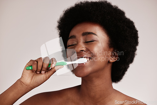 Image of Toothbrush, brushing teeth and black woman for clean and healthy mouth on studio background. Face of person advertising dentist tips for dental care, whitening and cleaning with a hygiene smile