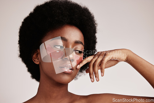 Image of Skin care, eye mask and a black woman in studio with dermatology cosmetic product. Aesthetic model with hands for collagen gel patch for health, wellness and beauty face skin glow on grey background