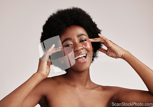 Image of Skin care, eye and face mask on black woman in studio happy with dermatology cosmetic product. Aesthetic model with hands for collagen patch for health, wellness and facial skin glow grey background