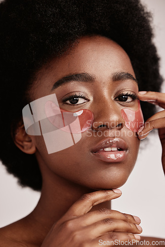 Image of Skincare, eye or face mask portrait of black woman in studio with dermatology cosmetic product. Aesthetic model with hand on spa collagen beauty patch for health, wellness and natural facial glow