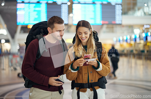 Image of Happy couple, airport and phone with ticket, travel app and adventure with excited face, conversation and smile. Man, woman and smartphone for digital booking of hotel, taxi or bus for transportation