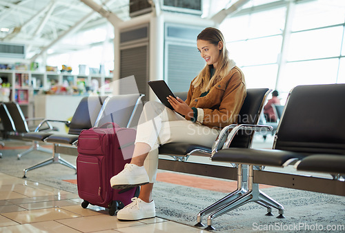 Image of Travel, tablet and woman relax in airport lobby, social media or internet browsing. Immigration, technology and female with touchscreen for networking, web scrolling and waiting for flight departure.