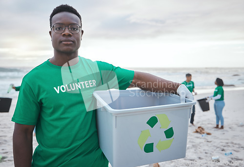 Image of Cleaning, recycling and portrait of black man on beach for sustainability, environment or eco friendly. Climate change, earth day or nature with volunteer and plastic for charity or community service