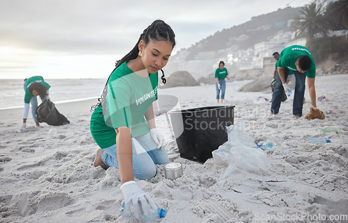 Image of Teamwork, cleaning and recycling with black woman on beach for sustainability, environment and eco friendly. Climate change, earth day and nature with volunteer and plastic for community service