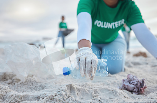 Image of Hands, plastic and volunteer at beach cleaning for environmental sustainability. Recycle, earth day and woman or charity activist picking up bottle, trash and garbage for recycling to stop pollution.