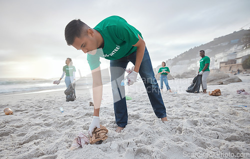 Image of Teamwork, cleaning and recycling with man on beach for sustainability, environment and eco friendly. Climate change, earth day and nature with volunteer for community service, pollution and plastic